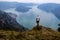 A Man on a Cliff in Mountains next to Italian Alpine Lake Iseo a