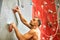 Man climber on artificial climbing wall in bouldering gym