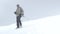 A man climber, descends the snow-covered slope down to the base camp. Mount Elbrus, the Caucasus Mountains.