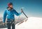 Man climber holding ice axe on mountain