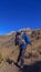 A man climbing a hill in the mountains of iztaccihuatl volcano