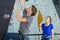 Man climbing indoor wall being timed by coach with stopwatch