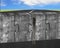 Man climbing ladder on four huge puzzles connected concrete wall