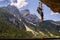 Man climbing on Laserer alpin via ferrata over Vorderer Gosausee lake with Grosser Donnerkogel