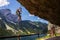 Man climbing on Laserer alpin via ferrata over Vorderer Gosausee lake with Grosser Donnerkogel