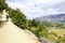 Man is climbing on the mountain with little girl on the shoulders. lake Wanaka town. New Zealand