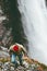 Man climbing in mountains waterfall