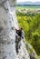 Man climbing natural rocky wall.
