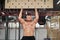 Man climbing pegboard gym athlete training arm strength stamina alpinism indoor. Ideal body with perfect abs naked torso