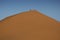 Man climbing sand dune