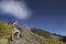 Man Climbing Up Boulder In Forest Valley