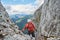 Man climbing via ferrata Intersport near Gosau, just before the well known diagonal ladder