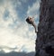 Man climbs a high danger mountain with a rope