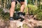 Man climbs in sneakers in outdoor action. Top View of hiking Boot on the trail. Close-up Legs In Jeans And sport trekking shoes on