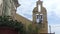 A man climbs the stairs to the bell tower and rings the bells in a village church.