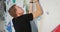 A man climbs up the artificial surface of the climbing wall, striving for top