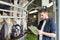 Man with clipboard and milking cows on dairy farm