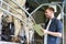 Man with clipboard and milking cows on dairy farm