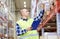 Man with clipboard in safety vest at warehouse