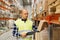 Man with clipboard in safety vest at warehouse