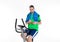 Man with clipboard train on fitness machine