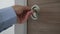 Man close and lock apartment door rotating with hand the door lock system