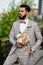 Man Clothed Stylish Suit Holding Bouquet of Flower