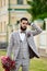 Man Clothed Stylish Suit Holding Bouquet of Flower