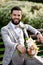 Man Clothed Stylish Suit Holding Bouquet of Flower