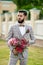 Man Clothed Stylish Suit Holding Bouquet of Flower