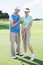 Man coaching his partner on the putting green