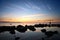 Man on the coast and bright sunset over the sea