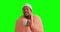 Man, coffee and blanket on a green screen for comfort, winter and warmth in a cup. Black person drinking tea with a