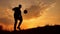Man coins a ball European the football soccer freestyle silhouette at sunset sunlight. man beats chasing ball football