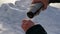 A man in the cold pours tea from a thermos