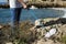 Man collecting garbage next to the beach