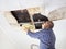 Man Collecting Water In basin From Ceiling