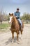 Man comes back after a ride on his Quarter horse at Aguanga, CA, USA