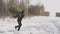 A man comes out of the forest with a Christmas tree in the snow in winter. Concept of traditional holiday new year and