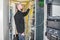 A man commutes Internet wires in a server rack. The system administrator works in the server room of the data center. The