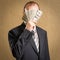 Man concealing his face with a fistful of money