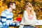 Man confess love to girl on bench in park.