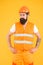 Man in construction. Working man yellow background. Bearded man in hard hat and safety vest. Skilled man with beard and