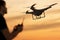 Man is controlling flying drone at sunset. 3D rendered illustration of drone