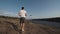 Man controlling quad copter on river shore