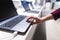 man controls the computer with a touchpad. A man`s hand uses a laptop in the electronics store