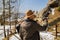 Man controls the flying drones in snowy forest winter. Adventurous winter holiday