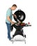 Man cooking on barbecue grill, white