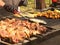 A man is cooking barbecue on an open fire. The cook flips the baked fish. Grilled meat and ribs. Fatty high-calorie foods with