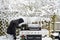 A man cooking on the barbecue in a snowstorm